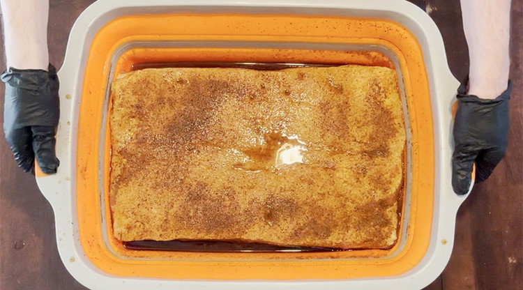 Image of At the end of the 5-7 days. Open the container and pour out the liquid. Take out the pork belly and brush off excess spices. Pat pork belly with a paper towel to dry any extra moisture.