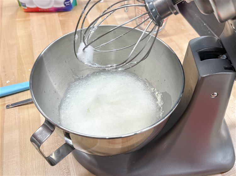 Image of Combine 1 cup of egg white powder with ¾ cup water in the bowl of a stand mixer or an electric mixer.  Beat on high until the mixture is just becoming frothy, about 2 minutes 