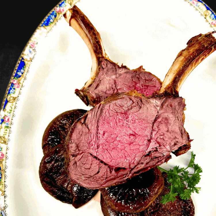 Image of Slice in between the bones (holding the bones for leverage), with long strokes so as not to leave sawing knife marks across your meat.