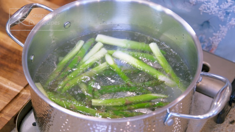 Image of Bring a pot of water to a boil over medium heat. Add a drizzle of oil and toss in the asparagus. The oil will help to retain the vivid green color so your dish looks nicer.