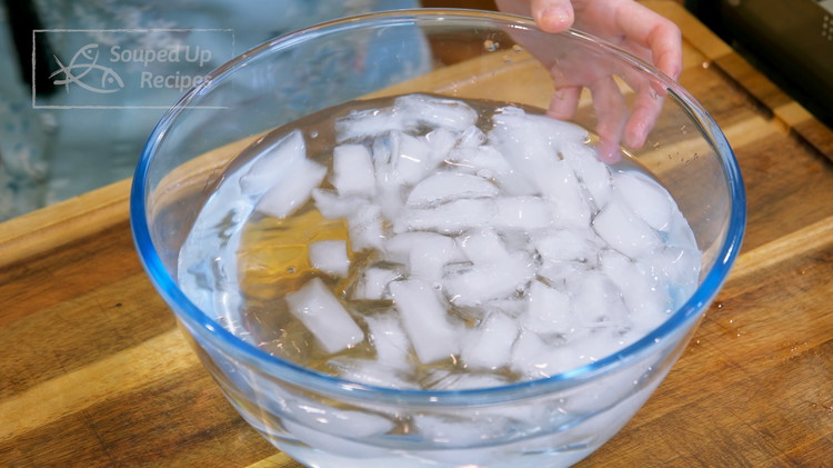 Image of Prepare a bowl of ice water on the side. Take the lobster out of the water and shock it with the ice bath to stop the cooking process.
