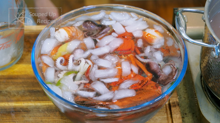 Image of Remove all the seafood from the water and add to the ice bath to stop the cooking process.