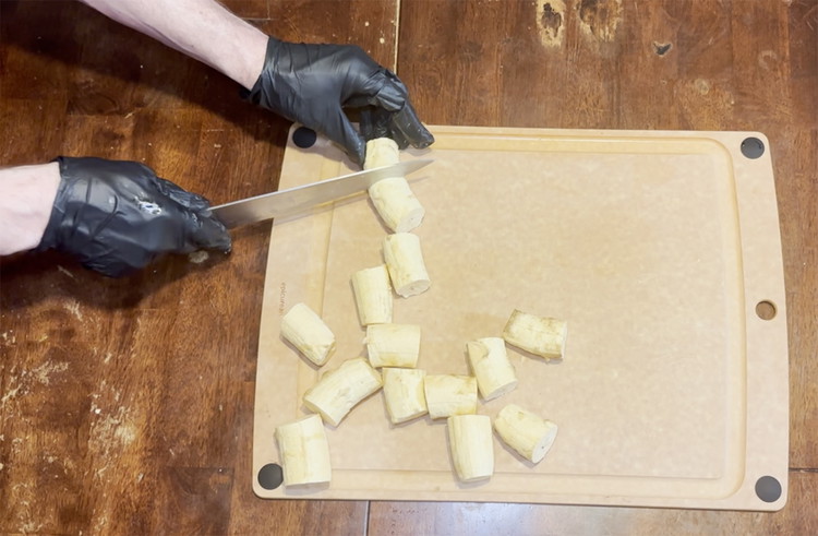 Image of Slice plantains into pieces around 1 ½  inches thick. You want 3-4 equal size pieces per plantain depending on size.