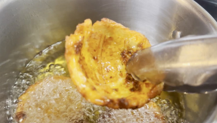 Image of Add plantain bowls back into the oil in batches and fry until crispy.