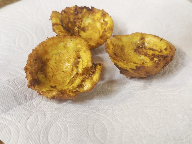 Image of Remove from oil and let dry on top of a paper towel. Repeat with the remaining plantain pieces.