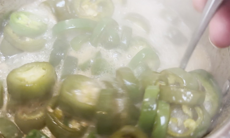 Image of Raise heat to a boil again and add in jalapeno slices. Once all mixed, reduce to a simmer for 4 minutes.