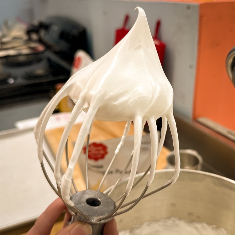 Image of In a stand mixer or with an electric mixer, whip the meringue and water together on medium-high speed until stiff, glossy peaks form. This will take about 9-12 minutes. You should be able to hold the whisk upright, and the peak on the end of the whisk will hold its shape.