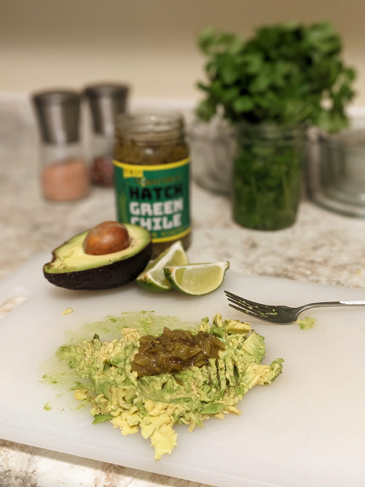 Image of Make smashed avocado. Peel and remove pit from avocado and lightly smash with a fork. Add about 2 teaspoon lime juice, a pinch of salt, and 1 Tablespoon Chopped Chile Co. Green Hatch Chiles and lightly smash until just combined....