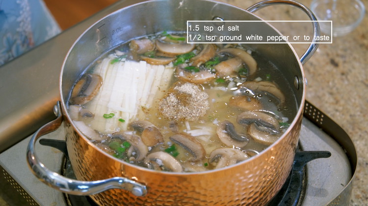 Image of Add the tofu to the pot and season the soup with salt and white pepper to taste.