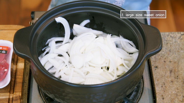 Image of Add 5 Tbsps of vegetable oil and the onion slices to a heavy-duty cookware, such as a cast iron pot, a Dutch oven, or a clay pot. I know that looks like a lot of grease, but this is the...