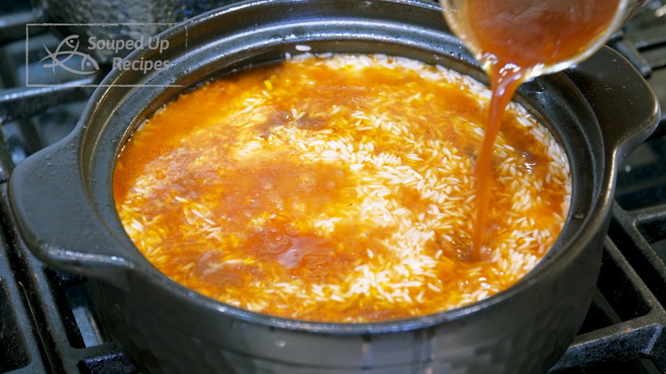 Image of Add the well-drained rice to the pot and spread it out evenly. Then, pour the braising liquid back. I can’t give you a measurement here, but what we are looking for is that the liquid is just enough to immerse...