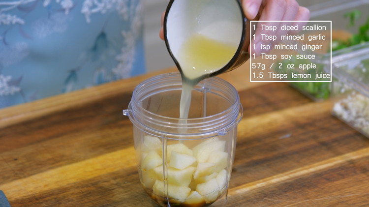 Image of In a blender cup, add 1 Tbsp diced scallion, 1 tbsp of minced garlic, 1 tsp of minced ginger, 1 tbsp soy sauce, 2 oz of apple, and 1.5 tbsp of lemon juice. Blend everything into a puree. 