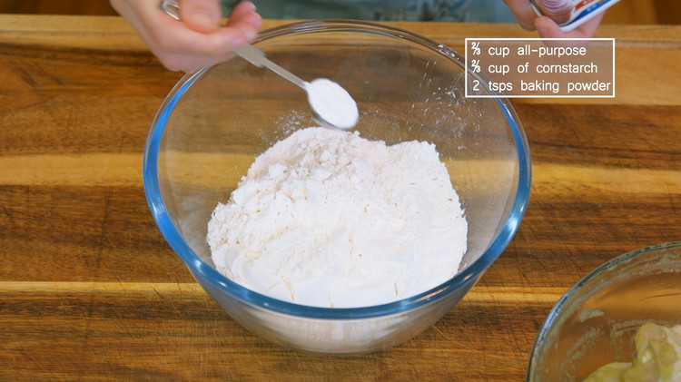 Image of In a large container, combine 2/3 cups all-purpose, 2/3 cups of cornstarch, and 2 tsps baking powder, which will introduce some fluffiness to the crust. Stir well. Cornstarch is the key to making the chicken crispy. If you use 100%...
