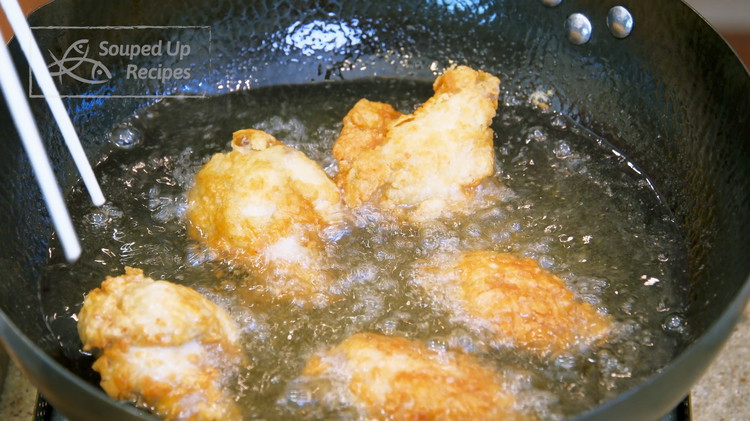 Image of Add 2 cups of oil to your wok and heat it to 350 F. Split the chicken wings into two batches. Fry each batch over medium heat for 5-6 minutes. Please flip the wings constantly to ensure even cooking. Once...