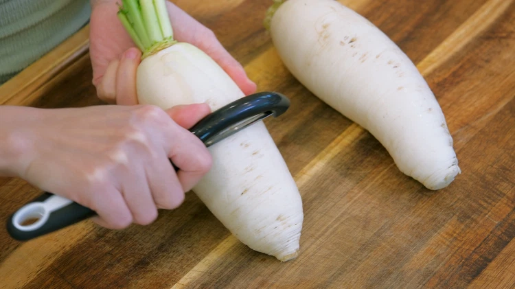 Image of Peel the radish skin. I suggest peeling another layer after the skin is removed. I found that the daikon radish in the USA is not as sweet as the ones that I had in China. It is more on the...