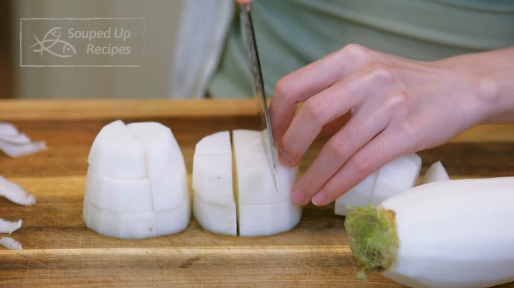 Image of Cut the radish into 2/3-inch thick rounds, then stack the rounds and cut them into bite-size pieces.