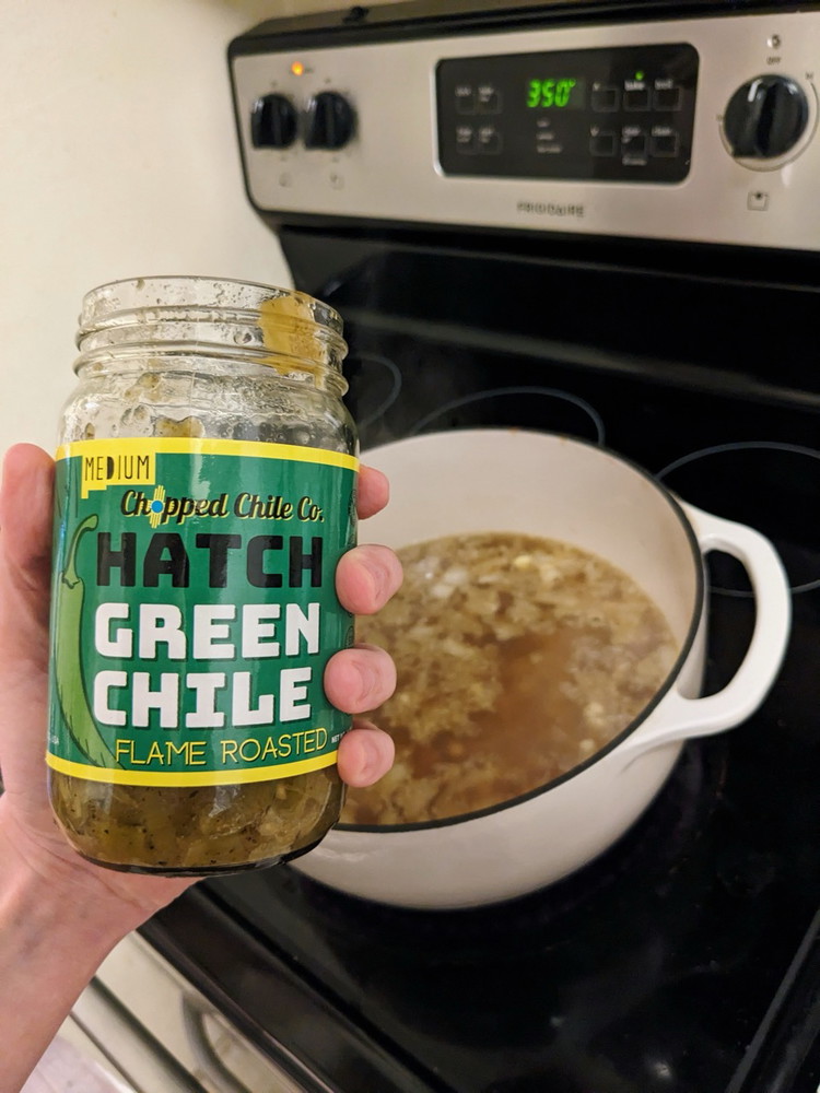 Image of Add pinto beans, cannellini beans, corn, and Chopped Chile Co. Green Hatch Chiles. Bring back to a boil, then reduce to a simmer and cook for 20 minutes. Season with salt and pepper.
