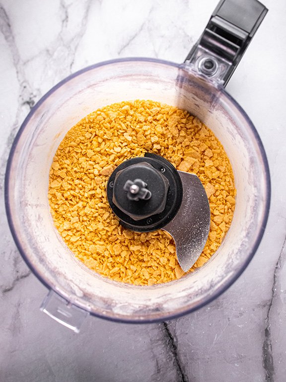 Image of Add cornflakes to a food processor and pulse until coarsely...