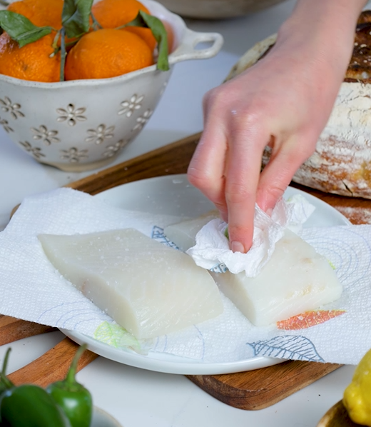 Image of Pat the halibut fillets dry with a paper towel to...