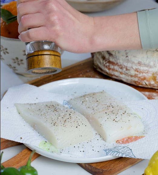 Image of Season both sides of the halibut fillets with salt and...