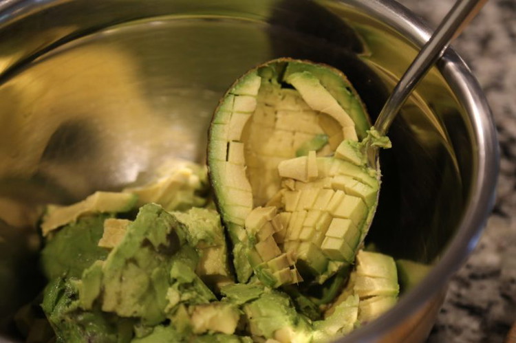 Image of Cut the avocados into dice inside the skins (this is easiest with a regular table knife) then scoop out with a spoon into a bowl.