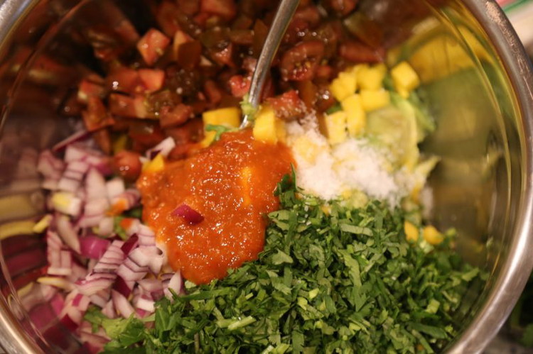 Image of Add the red onions, salt, lime juice, mango, Smoked Mango Habanero Hot Sauce, cilantro, and tomatoes and stir to combine. For the cilantro cut off the bottom two or three inches of stem and just chop the rest finely. There’s...