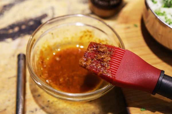 Image of Using scissors cut the lobster tails on the top and bottom and remove them completely from their shells being careful to keep them whole. De-vein the lobsters and then skewer lengthwise through the thickest part of each side of the...