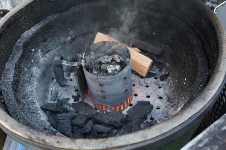 Image of Double Banked Fire. One good piece of pecan wood. Any good hardwood will do. Chicken soaks up smoke quickly. A jotisserie rotisserie and a nepolean basket to spin on the skewer and a piece of folded heavy duty foil down...