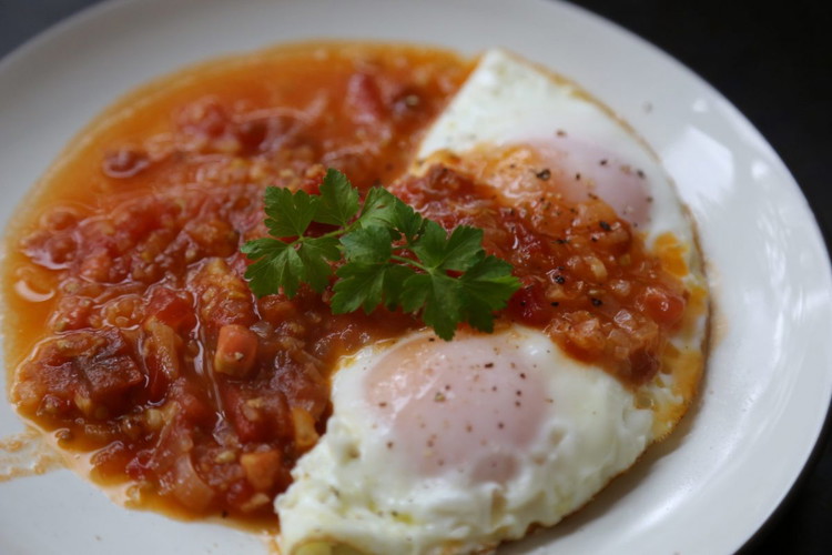 Image of Plate the eggs and top with the tomato/pepper mixture, add salt and pepper and serve with toast or rice to sop up all the goodness.