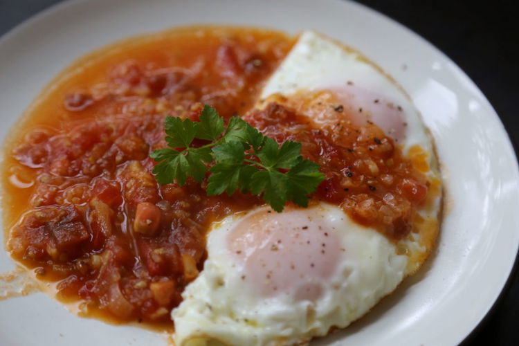 Image of Plate the eggs and top with the tomato/pepper mixture, add...