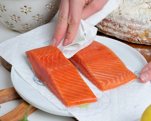 Image of Pat dry the thawed Sizzlefish Coho Salmon.