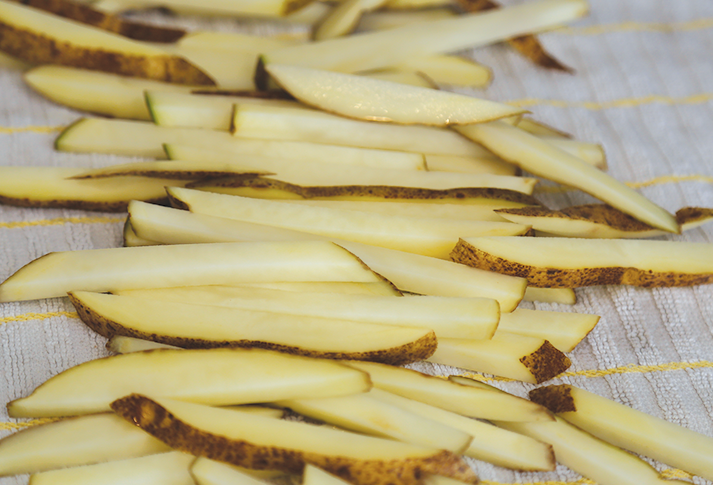 Image of Cut the potatoes into nice thin fries and place in a bowl of ice water for 15 minutes. Rinse them off and place them on a kitchen towel and give them a pat to dry. This helps to remove the...