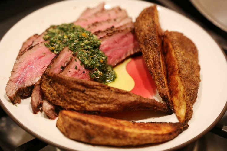 Image of Slice the meat thin against the grain. Your knife does the work so you’re mouth doesn’t have to. Spoon the Chimichurri sauce over the steak and serve with some of the juice from the steak.