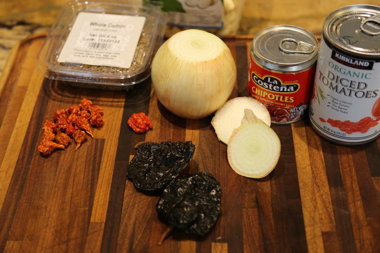 Image of Reconstitute dried peppers with 3/4 cup boiling water for at least 20 minutes. Blend peppers and water in a blender with a can of adobe chipotle peppers in their sauce and a can of tomatoes. Blend until smooth.