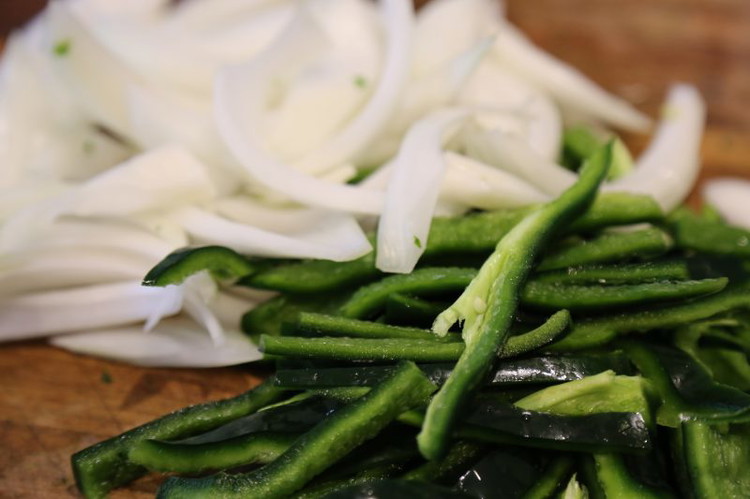 Image of Slice the onions and peppers till they are this pretty