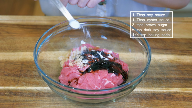 Image of Marinade the beef with 1 Tbsp of soy sauce, 1 Tbsp of oyster sauce, 2 tsps of brown sugar, ½ tsp dark soy sauce, and 1/4 tsp of baking soda and mix well. Set it aside for 10 minutes.