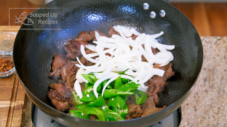 Image of Add the onion, chili pepper, and garlic. Stir for 1.5 minutes or until the vegetables are slightly soft.