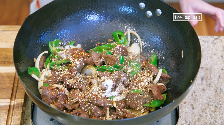 Image of Add the ground black pepper, red chili flake, roasted cumin seeds, sesame seeds, and 1/4 tsp of salt. Continue to fry for 30 seconds or until everything is well mingled.