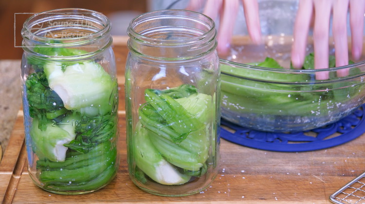 Image of When you see the surface of the vegetable become a bit moist, you can roll up the leaves and add them to the clean jars. It is better to put everything into one big jar, but I currently don't have...