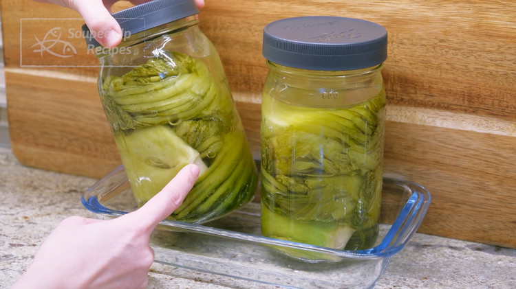 Image of Use glass weights to press the vegetables down below the liquid. Tighten the lid and let the mustard green ferment at room temperature for 15 days. During this time, you will see the color changing from green to brown. Recommend...