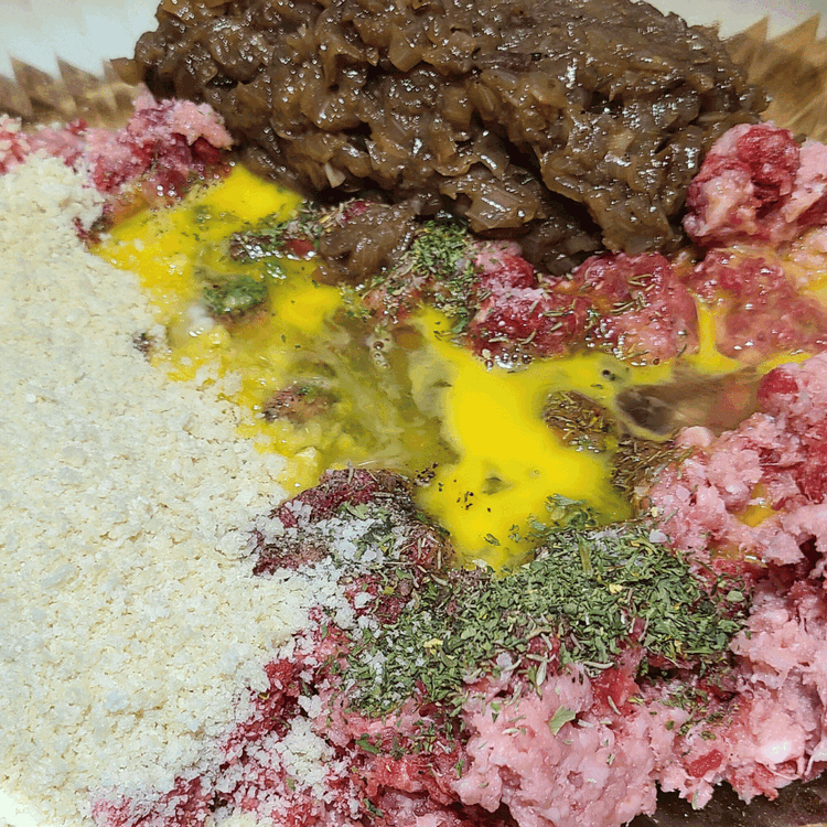 Image of Combine the ground bison, ground boar, egg, panko, salt, and pepper in a large bowl. Once the onions are cool enough to handle, roughly chop half the onions and add them to the meatball mixture.