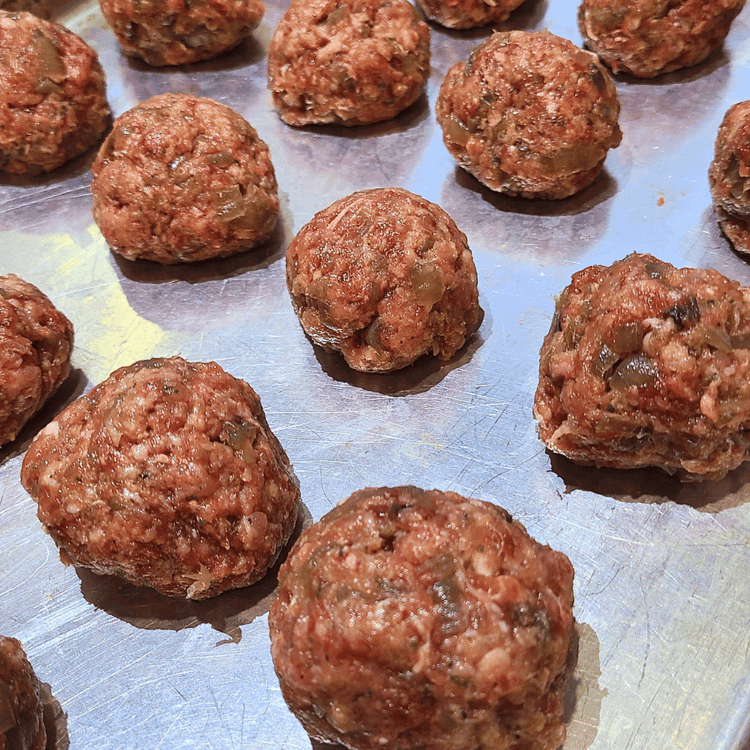 Image of Divide the mixture up into 24 roughly 1 1/2-inch balls. A foolproof way to make even balls is to use a cookie scoop. Roll the balls lightly in your hands, you want to form a ball, but not so hard...