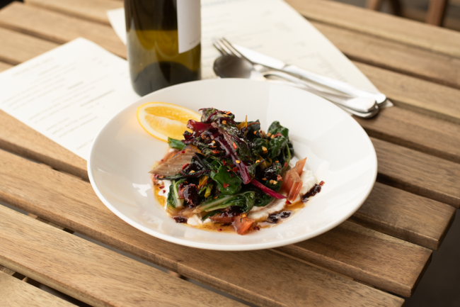 Image of sautéed greens with goat labne & olive jam dressing