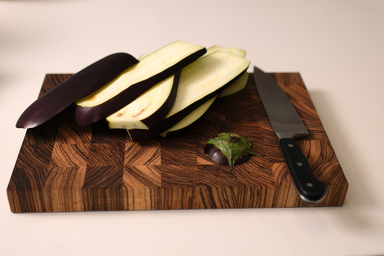 Image of Generously brush eggplant slices on both sides with olive oil.  Salt each side