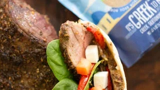 Image of To assemble gyros, layer lamb, onions and pepper, lettuce, tomato...