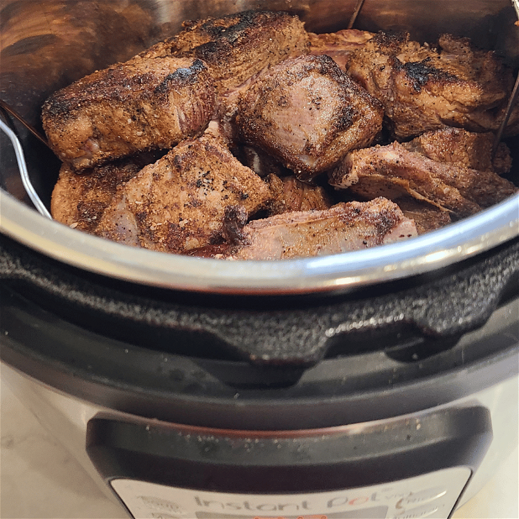 Image of Place the seared bison ribs on the rack, so that...