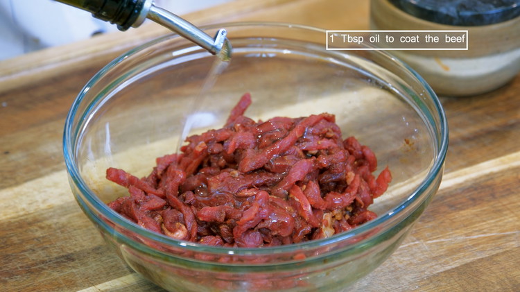 Image of Marinade the beef with 1/3 tsp of salt, 1/4 tsp of white pepper, 1 tsp of dark soy sauce, and 1/3 tsp of baking soda to tenderize the meat. Mix well. Drizzle in some cooking oil and stir to coat...