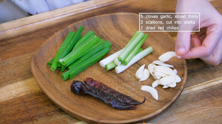 Image of Besides that,  slice 5 cloves garlic thinly; cut 3 scallions into stalks; cut a few dried red chilies into diagonal strips using a pair of scissors.