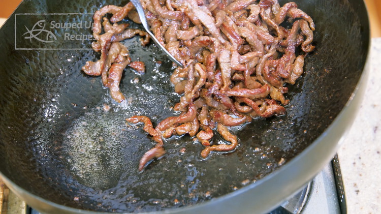 Image of Remove the beef from the wok. Make sure you tilt the wok so you can leave the excess oil behind.