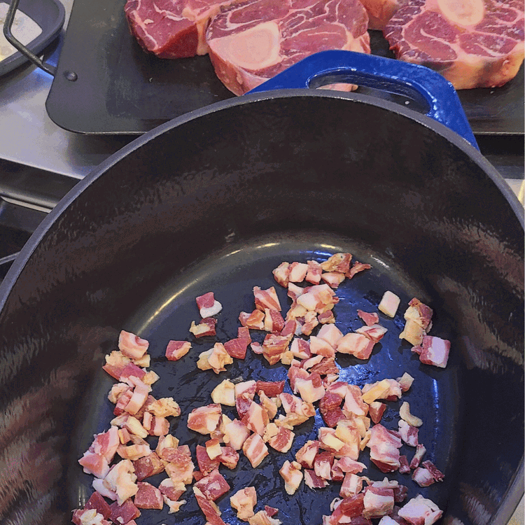 Image of Brown the pancetta by heating a Dutch oven on the stovetop over medium heat for about 5-10 minutes. Add pancetta to the Dutch oven, and cook, stirring occasionally.